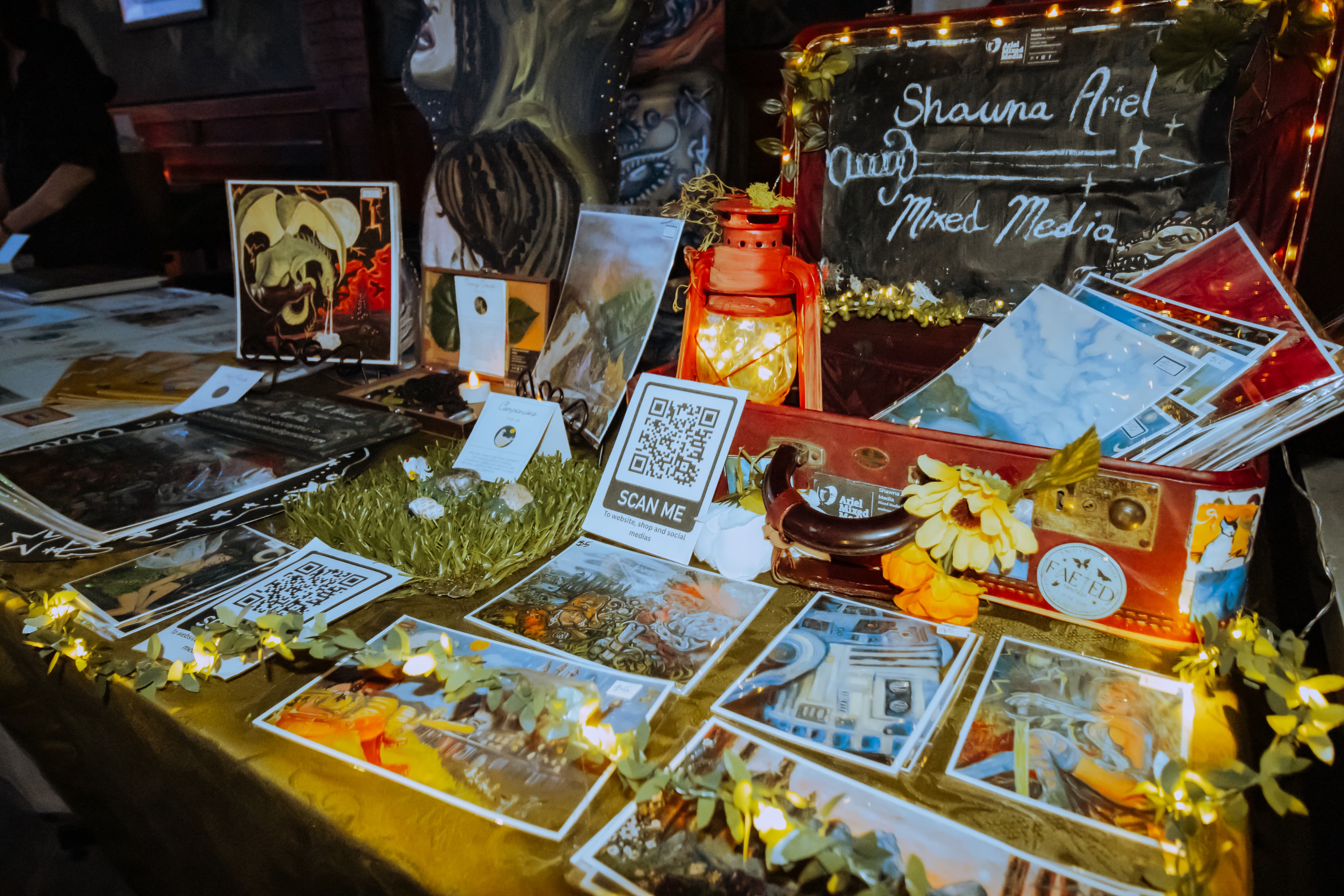 Mixed media art display table at a Champions of Hope event