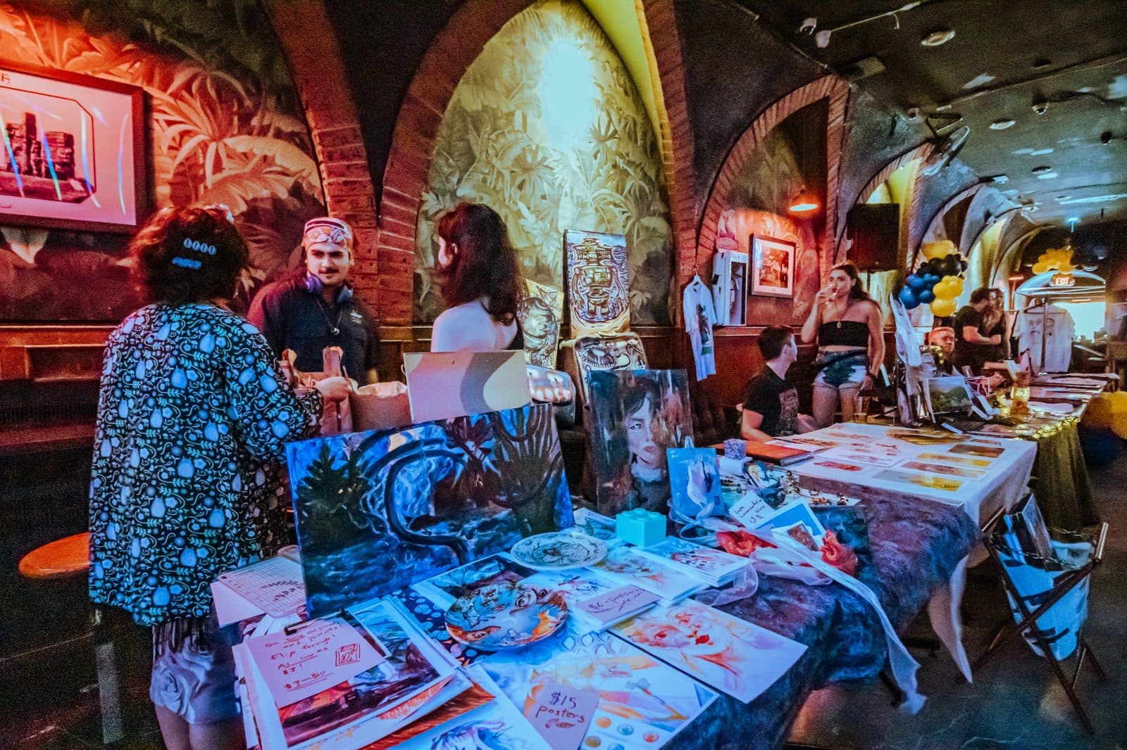 Local vendor tables and artwork set up inside the venue